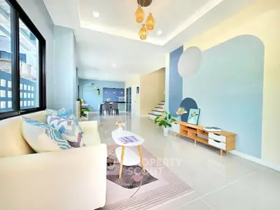 Modern living room with stylish decor and open layout, featuring elegant lighting and contemporary furniture.