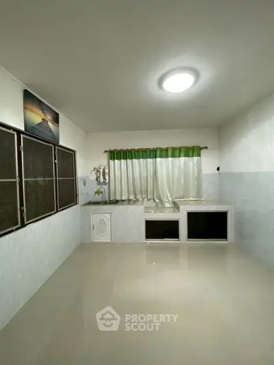 Spacious kitchen with closed layout and ample natural light.