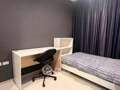 Modern bedroom with sleek design featuring a cozy bed and functional study desk.