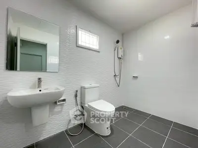 Spacious modern bathroom with sleek fixtures and minimalist design.