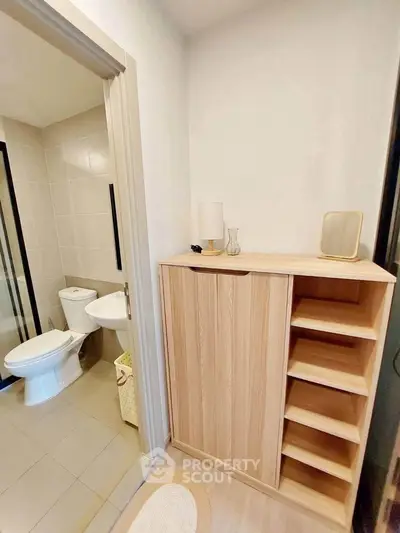 Modern bathroom with wooden storage cabinet and sleek fixtures
