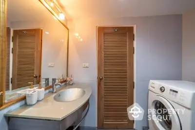 Modern bathroom with washing machine and stylish sink area