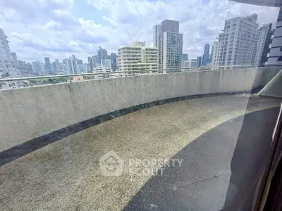 Spacious balcony with city skyline view, perfect for urban living.