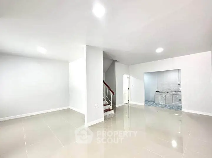 Spacious modern living area with sleek tile flooring and open layout