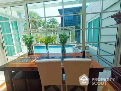 Luxurious dining area with pool view and modern glass doors