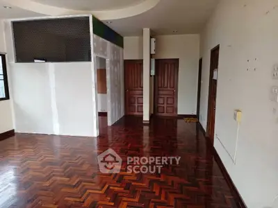 Spacious interior with elegant wooden flooring and unique architectural details.