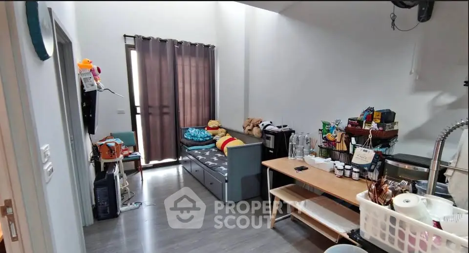 Cozy living room with modern decor and ample natural light, perfect for relaxation and entertaining.