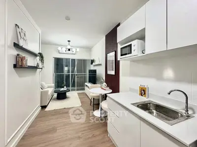 Modern open-plan kitchen and living room with sleek design and cozy ambiance.