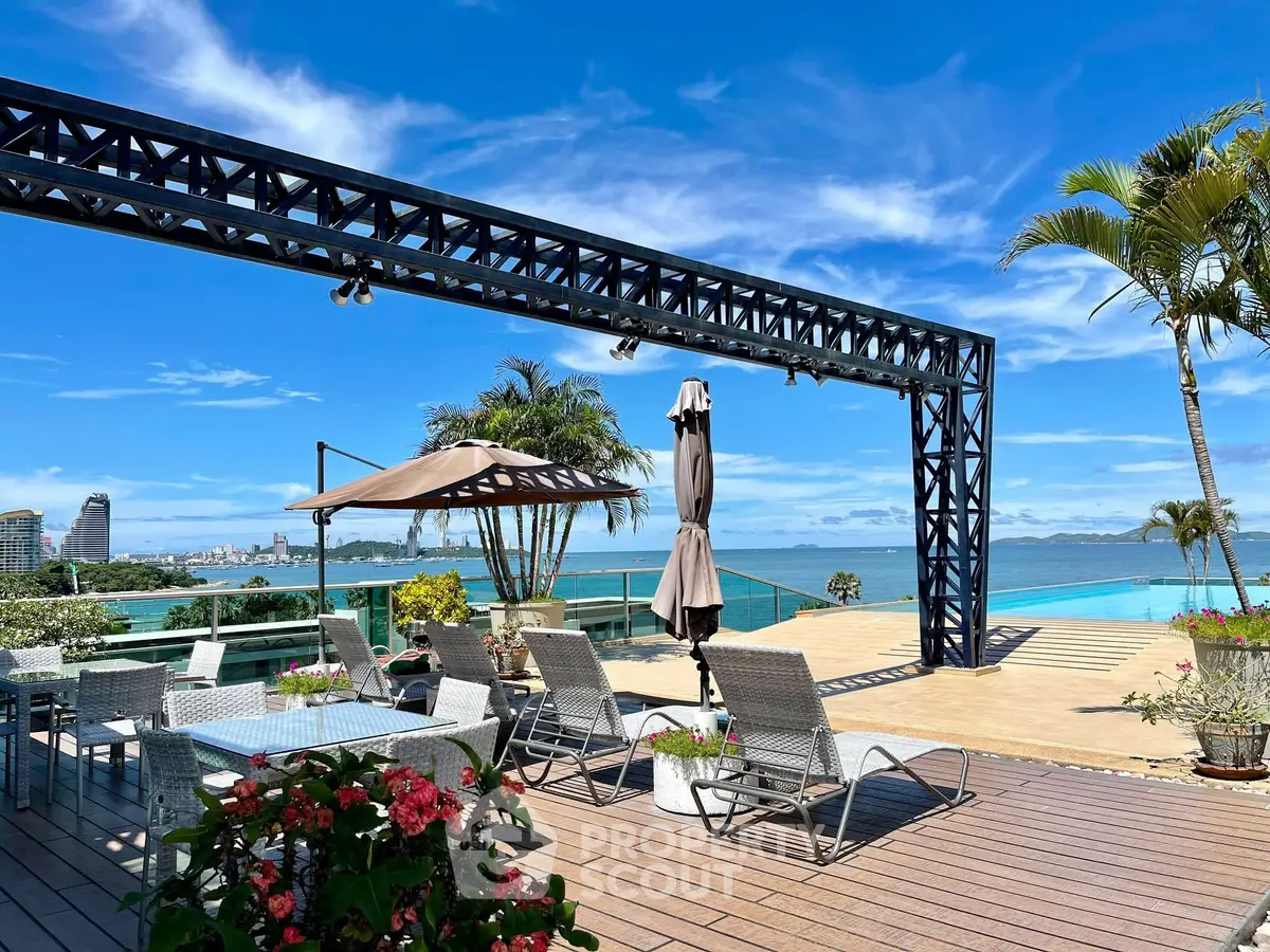 Stunning rooftop terrace with ocean view and lounge chairs, perfect for relaxation.