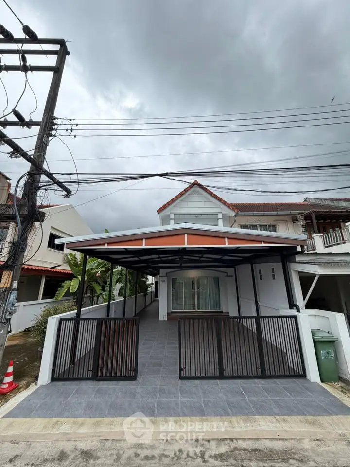 Charming two-story house with covered carport and modern exterior design, perfect for family living.