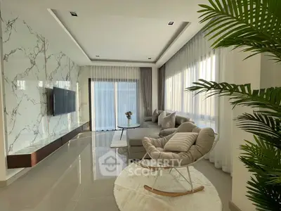Luxurious modern living room with elegant marble wall and cozy seating area.