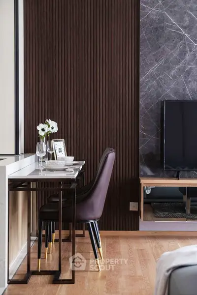 Stylish modern living room with elegant dining area and sleek TV setup