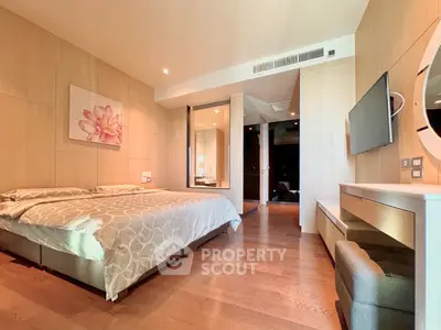 Spacious modern bedroom with elegant decor and wooden flooring