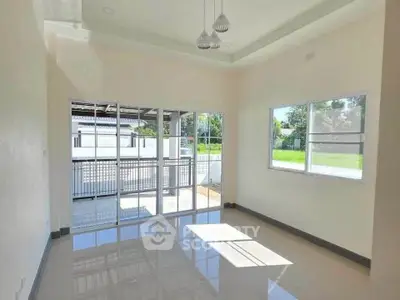 Bright and spacious room with large windows and glossy floors, perfect for natural light lovers.