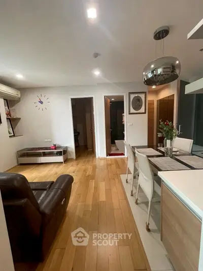 Modern living room with dining area and sleek wooden flooring