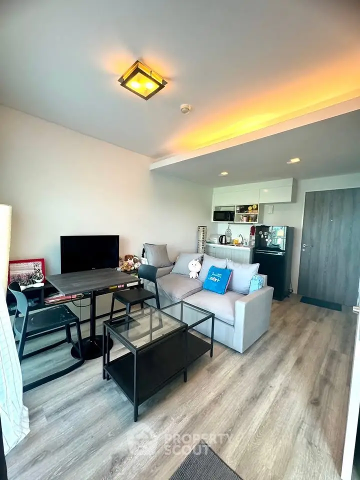 Modern living room with cozy seating and stylish decor in a contemporary apartment.