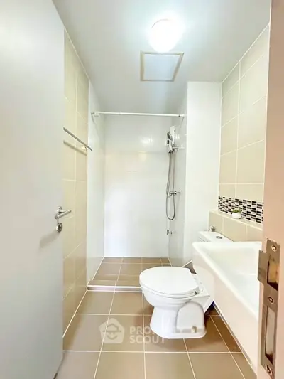 Modern bathroom with sleek fixtures and neutral tiles, perfect for a contemporary home.