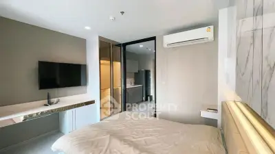 Modern bedroom with sleek design, featuring a wall-mounted TV and air conditioning, ideal for urban living.