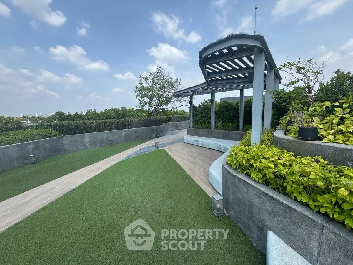 Stunning rooftop garden with lush greenery and modern pergola, perfect for relaxation and entertainment.
