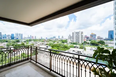 Spacious balcony with stunning city skyline view, perfect for relaxation and enjoying urban living.