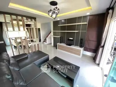 Modern living room with sleek furniture and stylish lighting, perfect for relaxation and entertainment.
