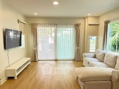 Spacious living room with modern decor and large windows for natural light