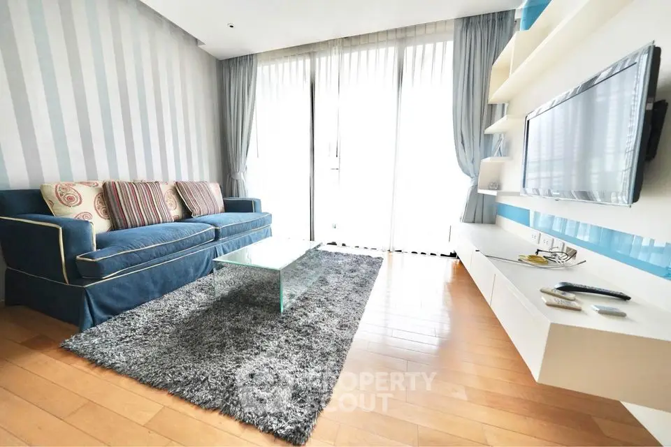 Stylish modern living room with cozy sofa and wall-mounted TV in bright apartment