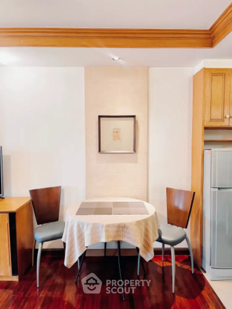 Charming dining nook with elegant table and chairs in cozy apartment setting.