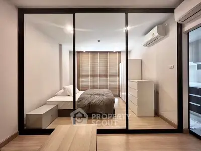 Modern bedroom with glass partition, minimalist design, and natural light.