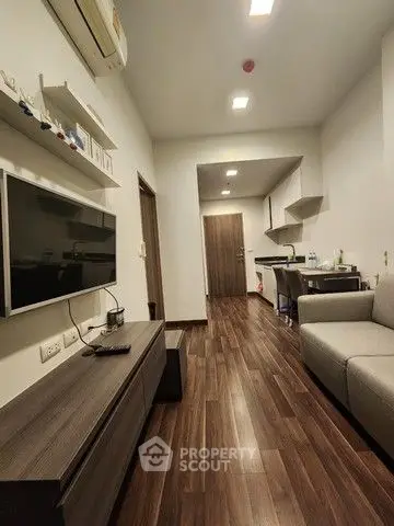 Modern living room with sleek wooden flooring and stylish furniture