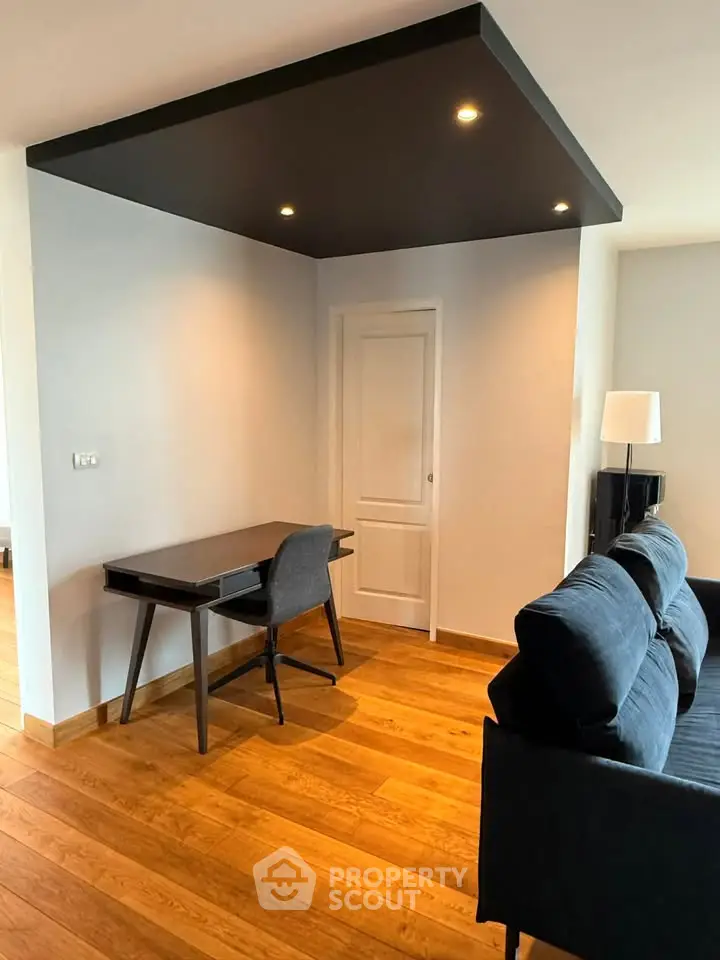 Modern living room with sleek furniture and wooden flooring