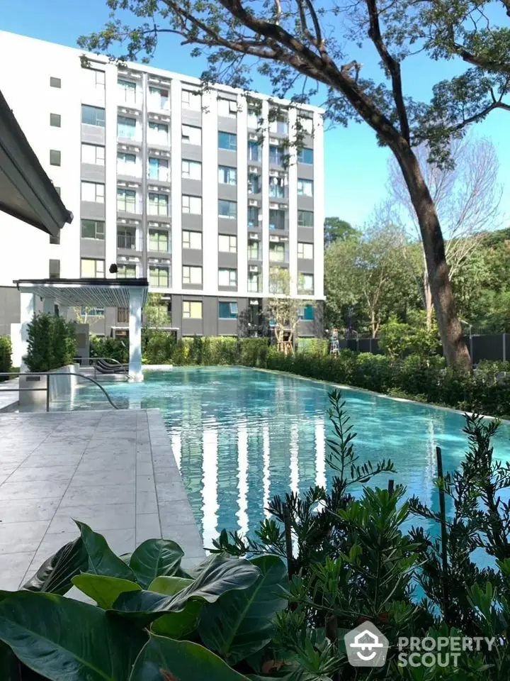 Luxurious apartment building with stunning pool and lush greenery