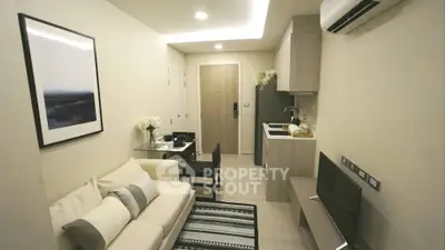 Modern compact living room with open kitchen in stylish apartment