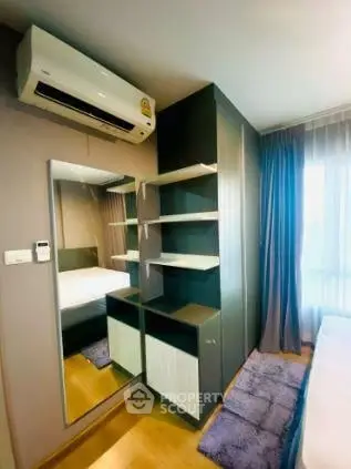 Modern bedroom with air conditioning and stylish shelving in a cozy apartment.