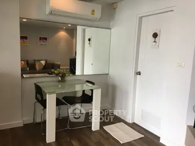 Modern dining area with glass table and air conditioning in cozy apartment