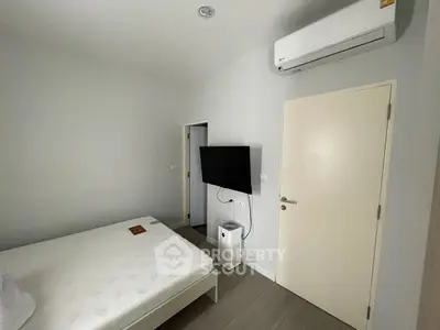 Modern minimalist bedroom with air conditioning and wall-mounted TV