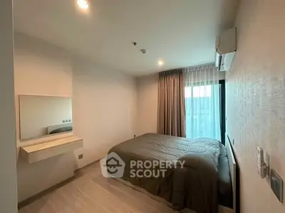 Cozy bedroom with modern decor and natural light, featuring a comfortable bed and stylish curtains.