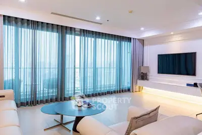 Spacious modern living room with large windows and elegant decor