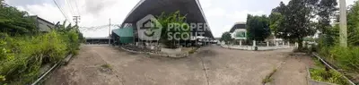 Expansive industrial property with large covered area and ample outdoor space.