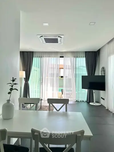 Modern living room with stylish decor and large windows for natural light