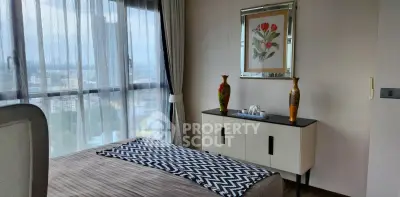 Elegant bedroom with large window offering stunning city views, stylish decor, and modern furnishings.