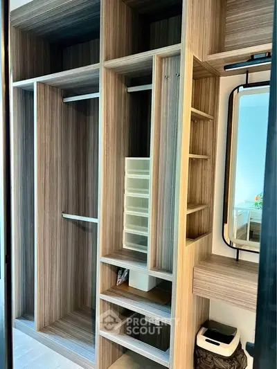 Spacious modern walk-in closet with wooden shelves and mirror