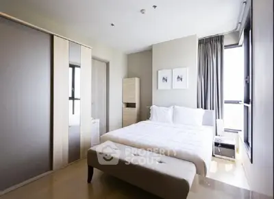 Modern bedroom with large windows and stylish decor in a high-rise apartment.