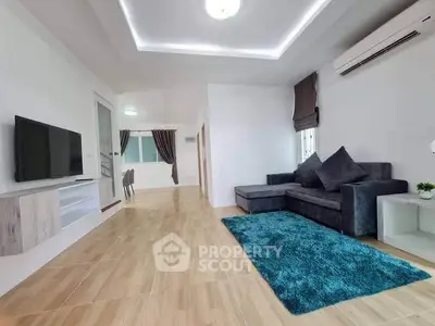 Spacious living room with modern decor and cozy seating area