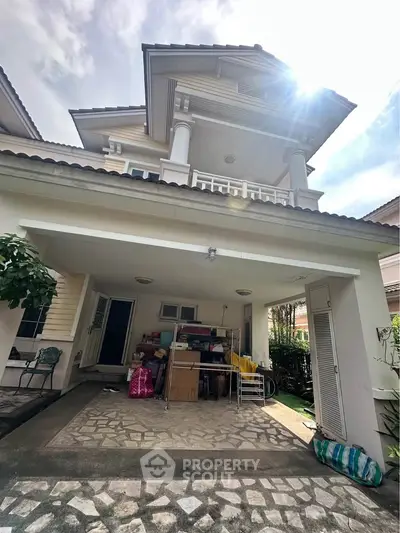 Charming two-story house with spacious driveway and elegant architectural details.