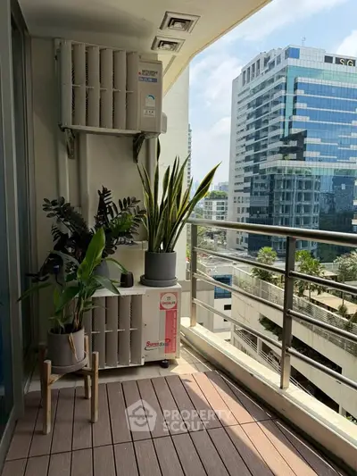Modern balcony with city view, featuring potted plants and sleek railing design.