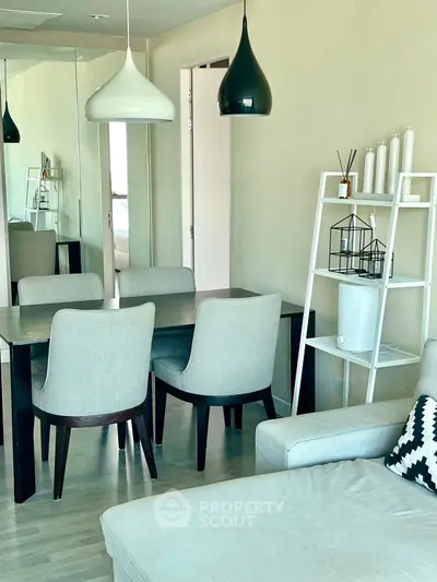 Modern living room with stylish dining area and pendant lights