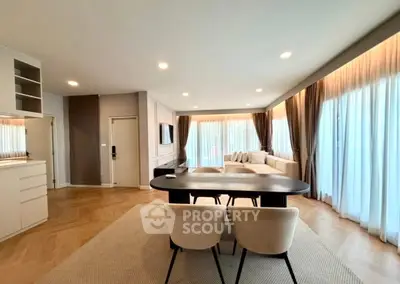 Spacious modern living room with elegant dining area and large windows