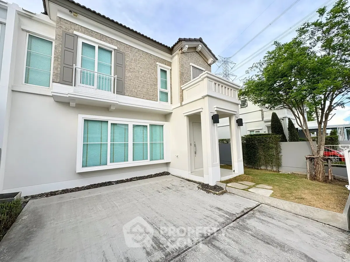 Modern two-story house with spacious driveway and elegant facade in a serene neighborhood.