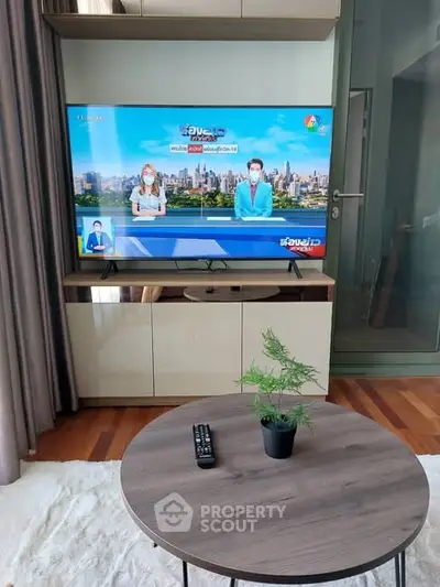 Modern living room with TV and stylish furniture, perfect for relaxation and entertainment.